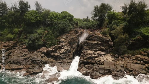 Aerial view Hummanaya Blowhole on southern coast of Sri Lanka, showcasing powerful ocean spray erupting through coastal rock cliffs near Kudawella village. Famous travel destination in Srilanka
