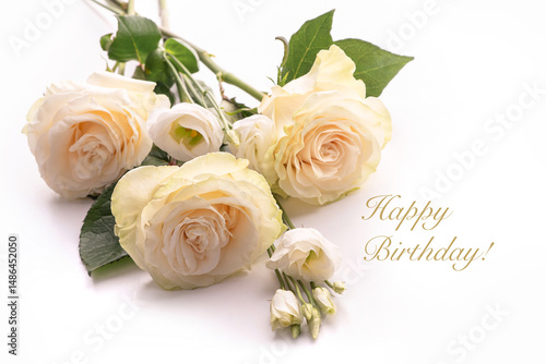 Three cream-colored roses and white buttercups lie on a white surface. Congratulations Happy Birthday!	