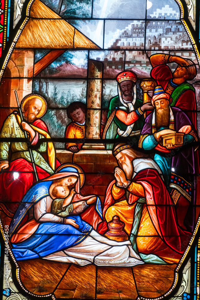 Obraz premium Stained glass (19th century) of Christmas Nativity Scene : Adoration of the Magi as they present gifts of gold, frankincense and myrrh to the Infant Jesus.