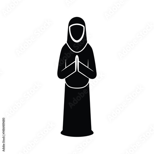 Muslim woman in niqab praying respectfully