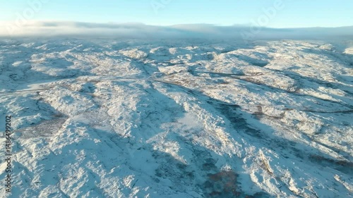 Drone captures sweeping aerial of Greenland Ice Sheet, covering 80% of landmass, showcasing vast frozen terrain, snow, and polar wilderness.