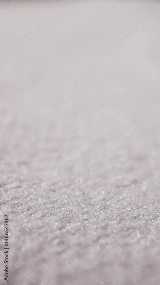 Motion above soft clean white fabric at bright light extreme close view. Textile sewing material texture. Texture of smooth flat cloth surface Motion above soft clean white fabric at bright light extreme close view. Textile sewing material texture. Texture of smooth flat cloth surface