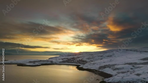Wallpaper Mural Dramatic sunset colors streak across the sky and reflect on frozen sea at Motovsky Bay’s rugged Arctic coastline. Torontodigital.ca