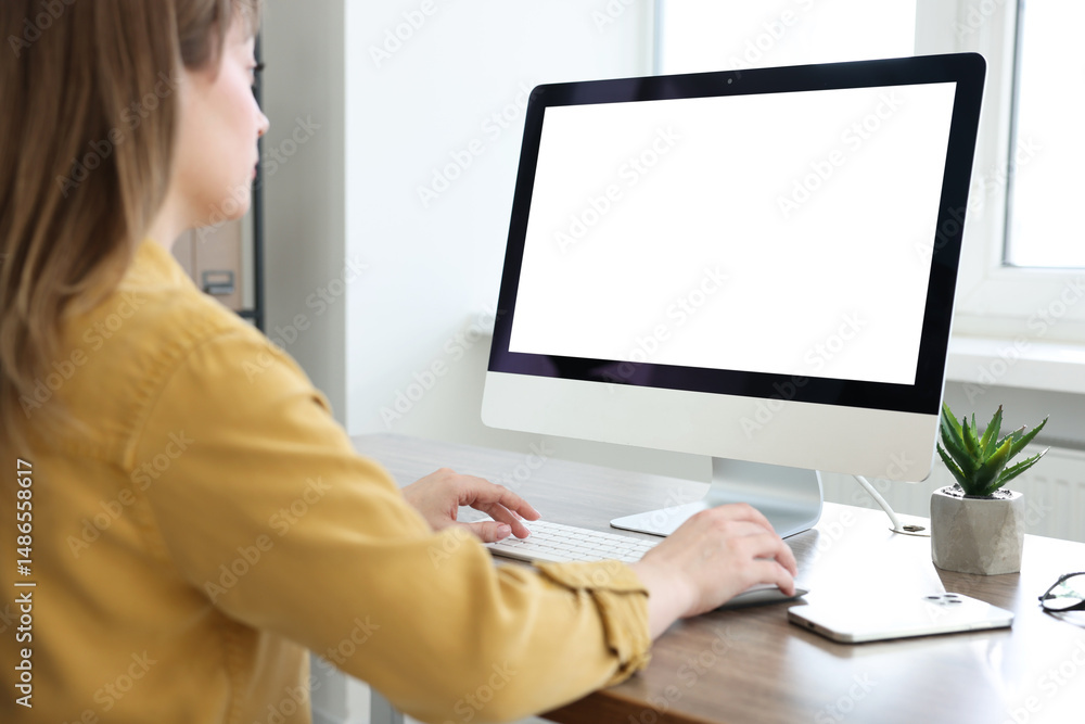 Woman working on computer at wooden desk in office. Mockup for design Woman working on computer at wooden desk in office. Mockup for design