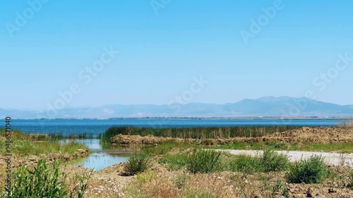 Wallpaper Mural Morning on the shore of a picturesque lake with snow-capped mountains in the background. Landscape in southern Turkey with Lake Beysehir on a sunny summer day, near Konya.4К Torontodigital.ca