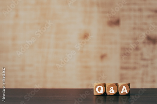 There is wood cube with the word Q&A. It is an abbreviation for question and answer as eye-catching image.