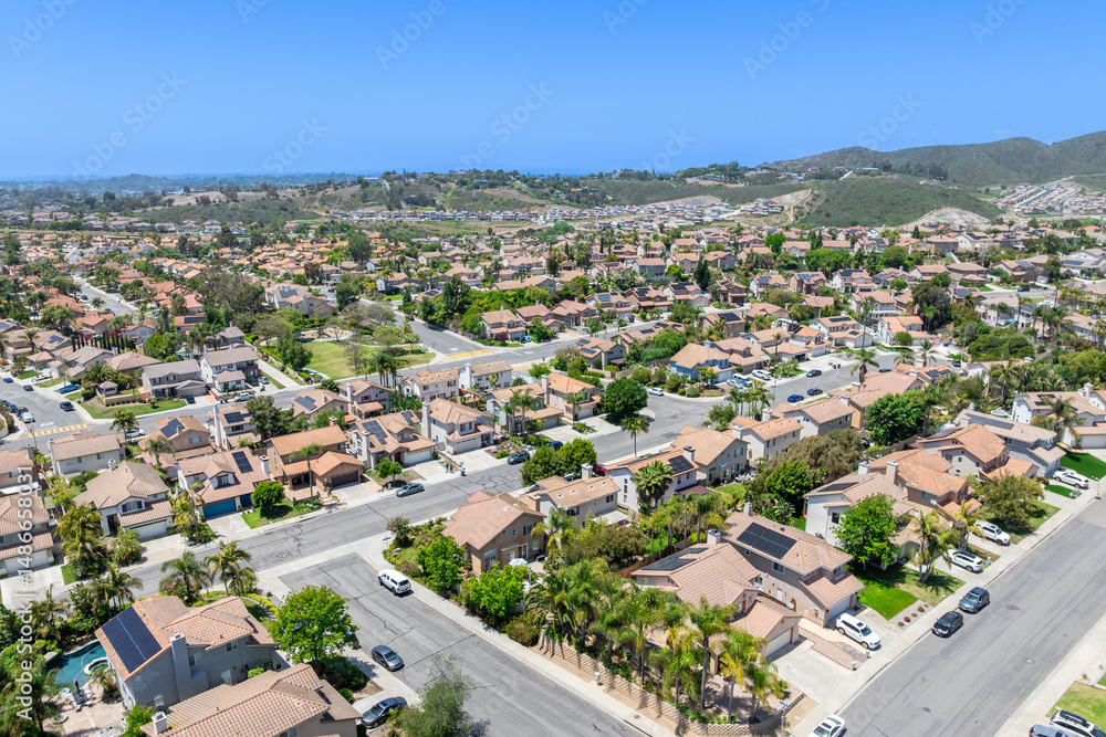 Fototapeta premium Aerial view of San Marcos neighborhood with houses and street during sunny day, South California, USA.