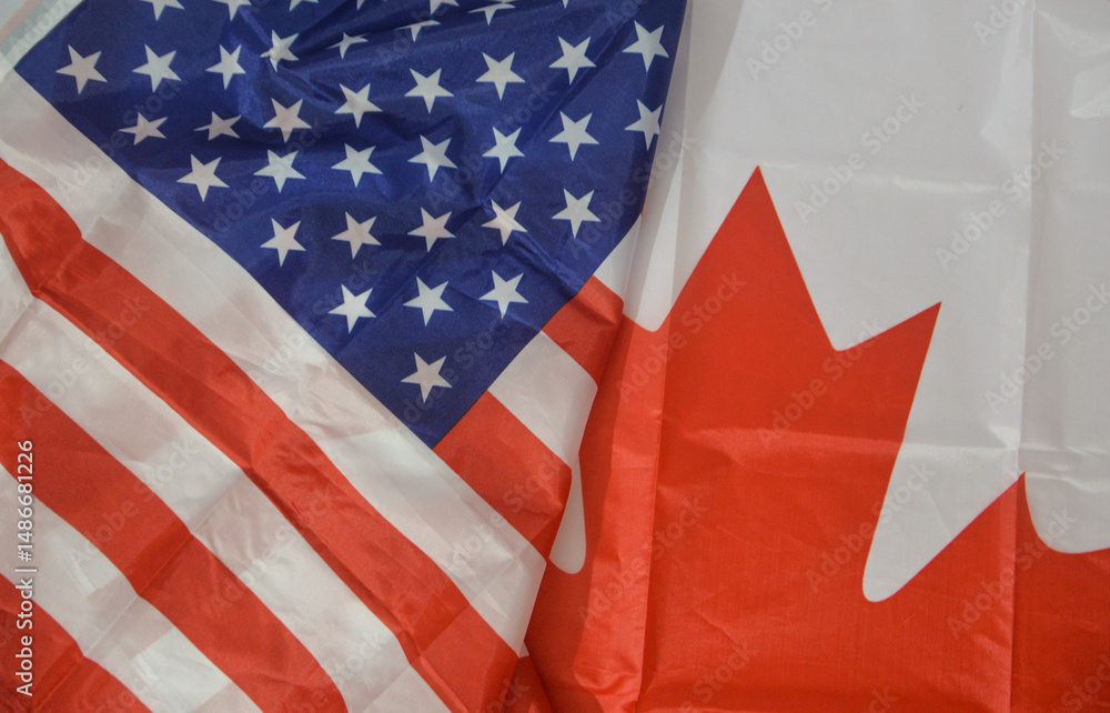 Obraz premium United States and Canada relations concept background with flags of both countries, top view. US and Canada political conflict, business, trade, tariff, diplomacy background