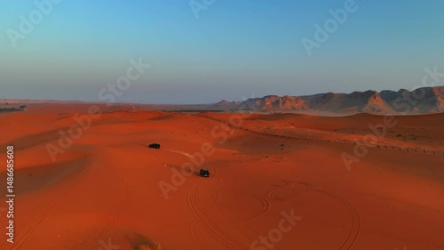 Aerial: Drone Forward Shot Of Off-Road Vehicles On Red Sand Dunes In Tranquil Desert - Riyadh, Saudi Arabia