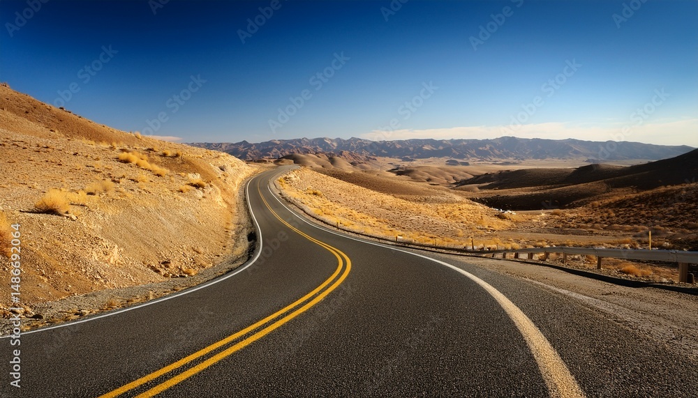 Fototapeta premium a wide angle perspective of a winding road with a yellow centerline cutting through dry barren hills representing an ongoing journey through a desolate yet picturesque landscape