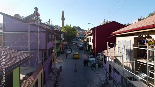 Wallpaper Mural Aerial: Drone Forward Slow Motion Shot Of People Walking Amidst Houses By Famous Mosque In Residential City Against Clear Sky - Afyonkarahisar, T�rkiye Torontodigital.ca