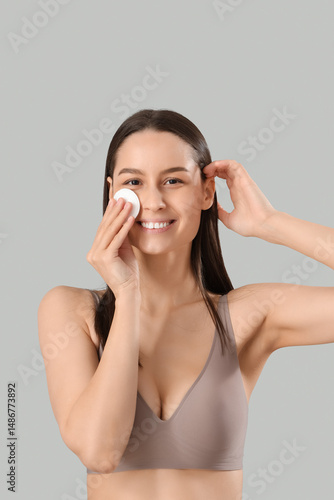 Young woman with cotton pad...