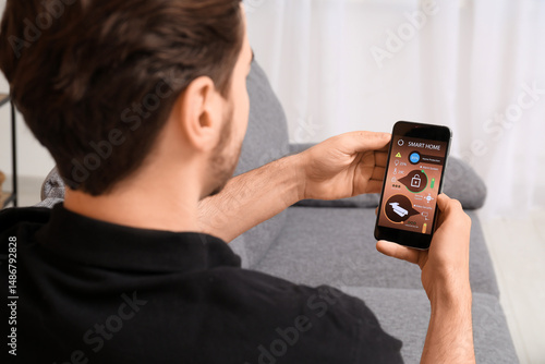 Young man using mobile phon...