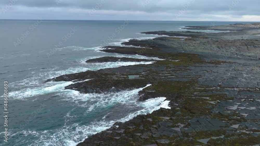 Aerial view of the rocky coastline of the Canary Islands with volcanic geology and waves crashing against the shore Aerial view of the rocky coastline of the Canary Islands with volcanic geology and waves crashing against the shore