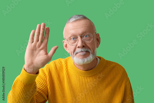 Senior man in eyeglasses wa...