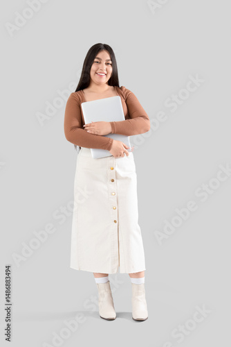 Young woman with laptop on ...