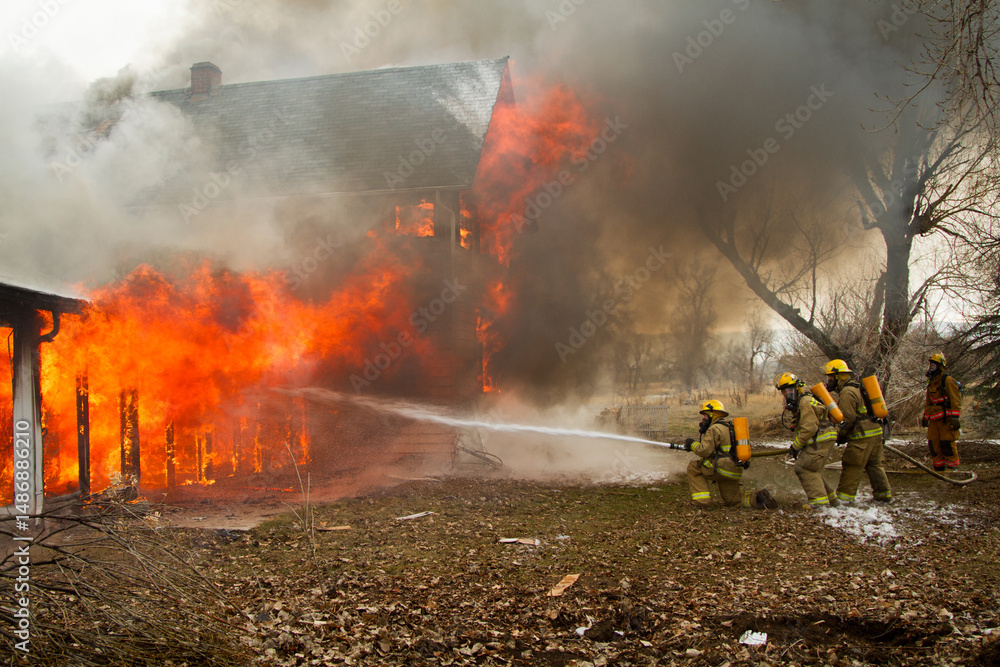 Fototapeta premium Firefighter water stream on a burning building