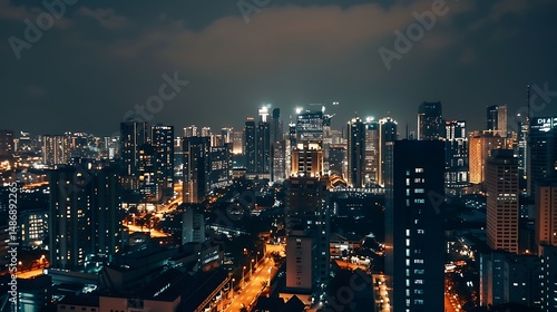 Aerial View of Illuminated City Buildings and Roads at Night With Dark Sky