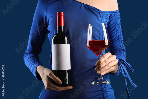 Woman in dress holding glas...