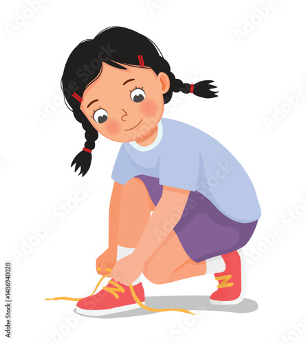 Little girl tying her shoelaces