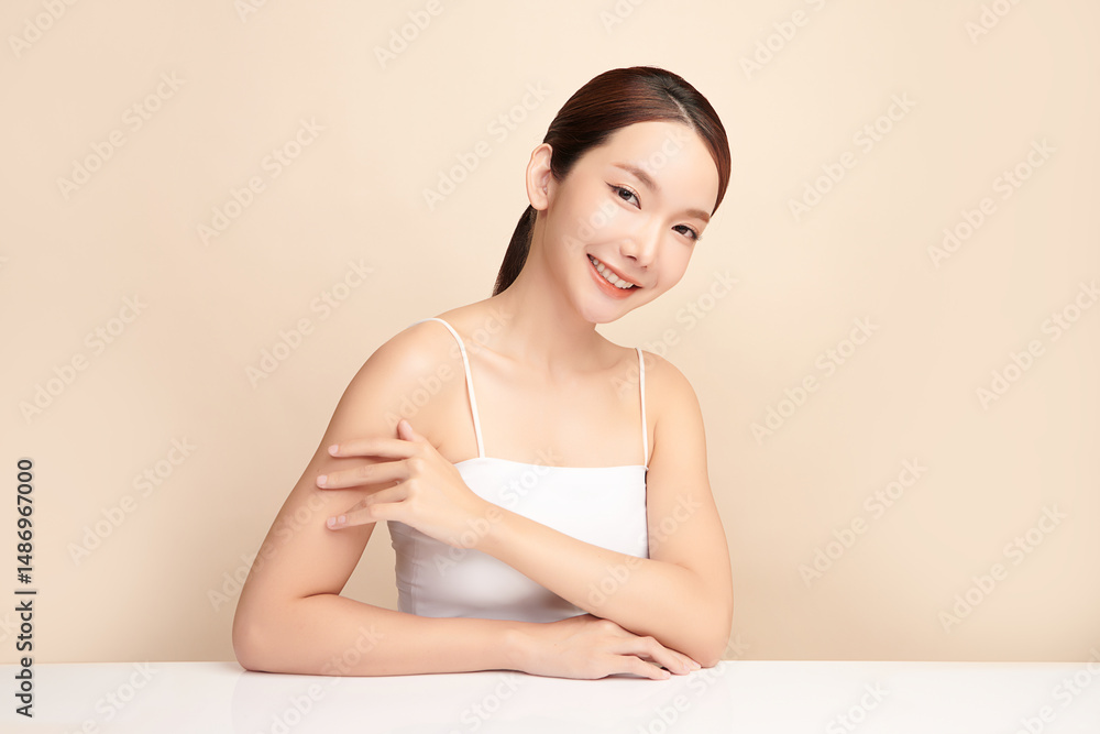A beautiful young Asian woman with clean, fresh skin against a beige background. Skincare, facial treatment, cosmetology, beauty, and spa. An elegant portrait of an Asian woman. A beautiful young Asian woman with clean, fresh skin against a beige background. Skincare, facial treatment, cosmetology, beauty, and spa. An elegant portrait of an Asian woman.