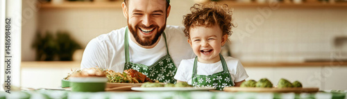 Father and daughter wearing green aprons enjoy festive meal together, smiling warmly in bright kitchen