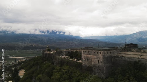Wallpaper Mural Aerial Forward Scenic Shot Of Historic Castle On Hilltop In Residential City Under Clouds - Gjirokaster, Albania Torontodigital.ca