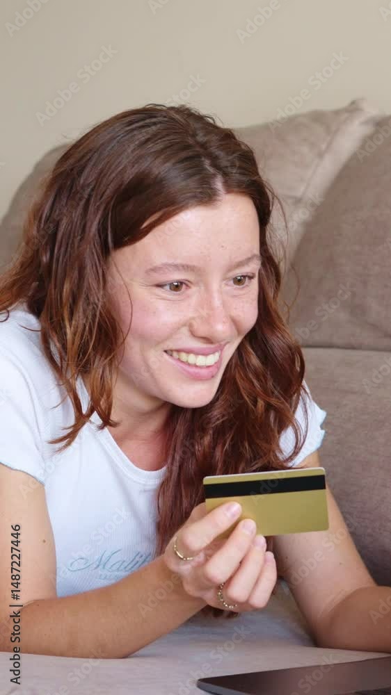 Happy woman paying online with credit card in slow motion Happy woman paying online with credit card in slow motion