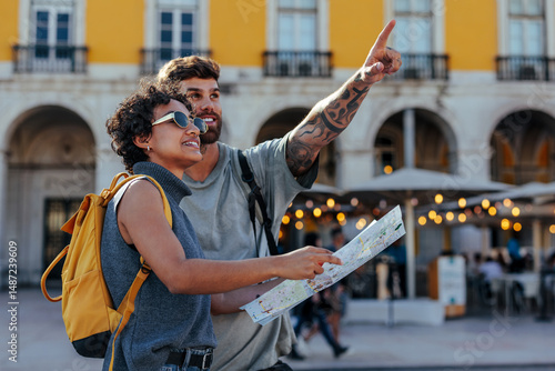 Tourists holding map and pointing in lisbon, portugal