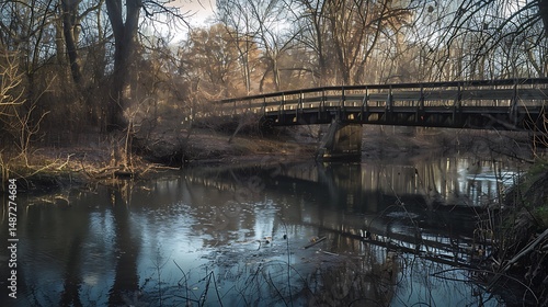 Wooden Bridge Spanning Over Reflective River Surrounded By Trees During Sunny Day