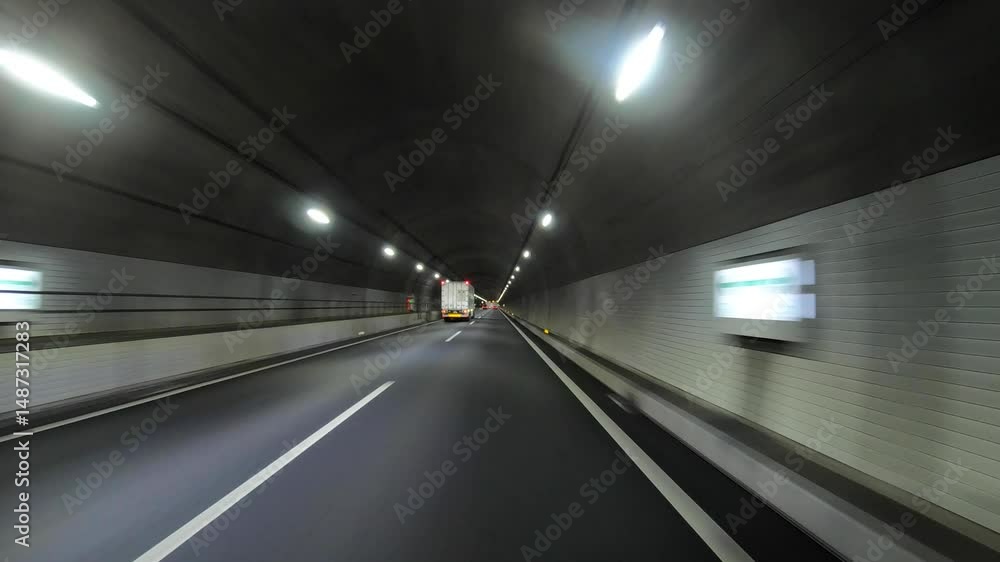 A pov during car driving on the highway tunnel in Japan in fall weather A pov during car driving on the highway tunnel in Japan in fall weather