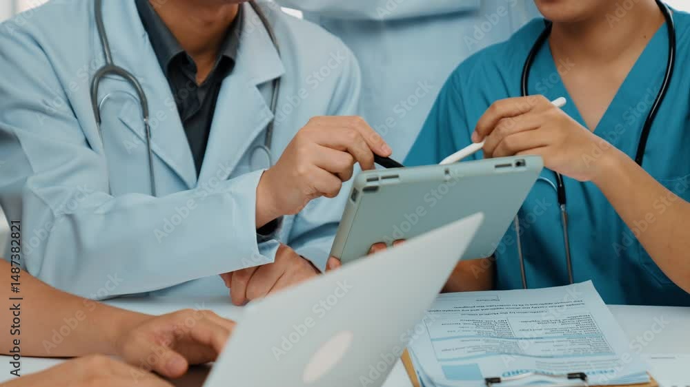 Professional group of medical working and planning medical treatment or healthcare system at hospital table together. Teamwork lead to successful illness and sickness treatment. Slow motion. Rigid. Professional group of medical working and planning medical treatment or healthcare system at hospital table together. Teamwork lead to successful illness and sickness treatment. Slow motion. Rigid.
