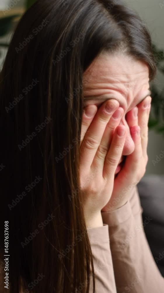 custom made wallpaper toronto digitalVertical video of sad woman suffering from strong eye pain. Eyesight problem. Tired young female touching eyes sitting on sofa at home interior living room. Injuries Poor health Illness concept