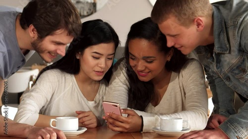 Two guys join two girls at the cafe