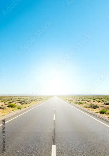 Empty road stretches to horizon under bright sky