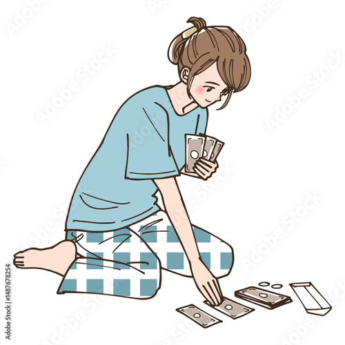 お金をどう使うか振り分けている女性