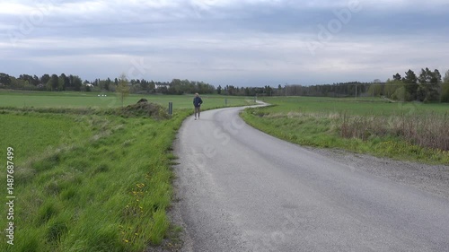 Stockholm, Sweden A man walks alone on a country road.