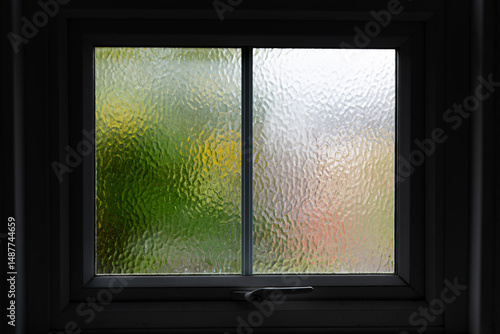 Frosted glass window with a view onto a sunny day