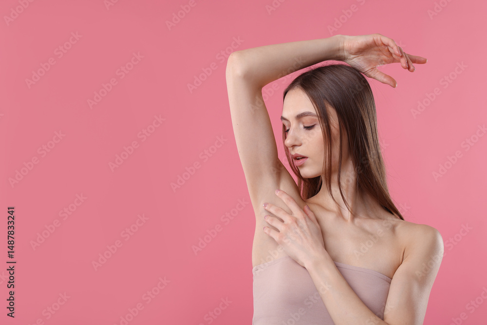 Fototapeta premium Young woman showing smooth skin after epilation on pink background, space for text