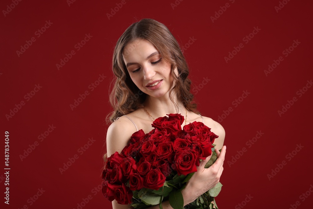Smiling woman with bouquet of roses on dark red background Smiling woman with bouquet of roses on dark red background