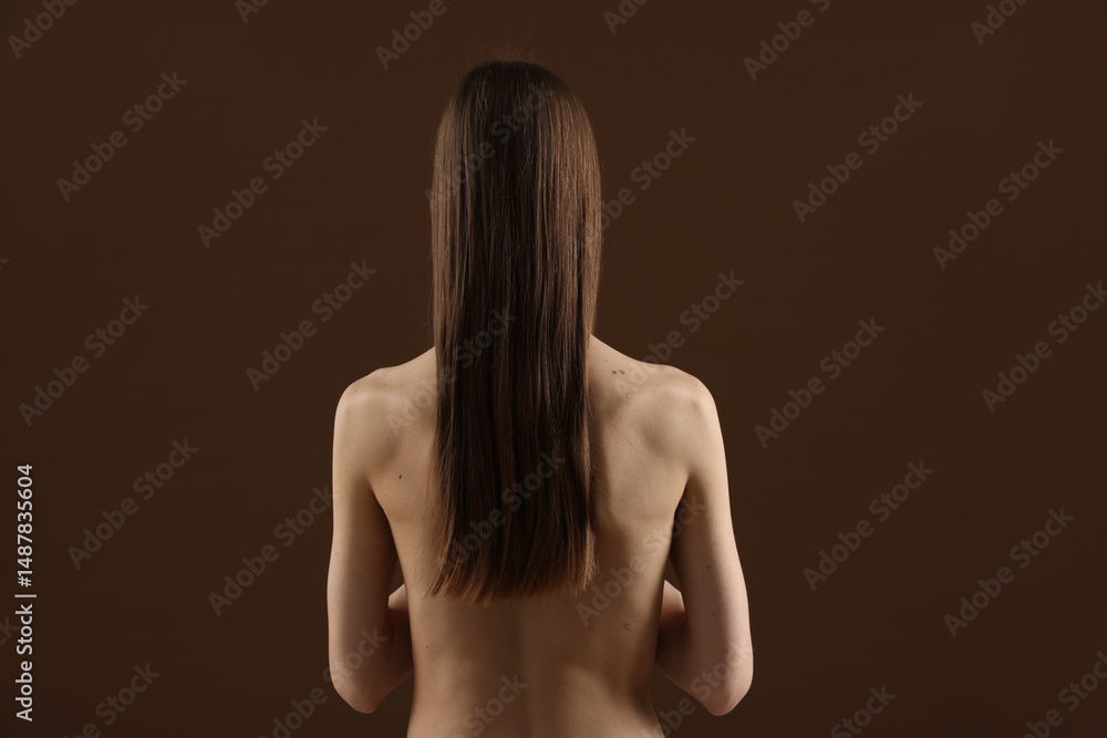 © New Africa - Nude woman on brown background, back view © New Africa - Nude woman on brown background, back view