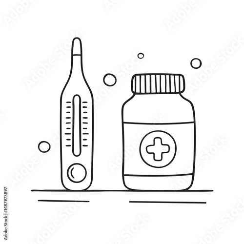 A thermometer beside a medicine bottle on the counter
