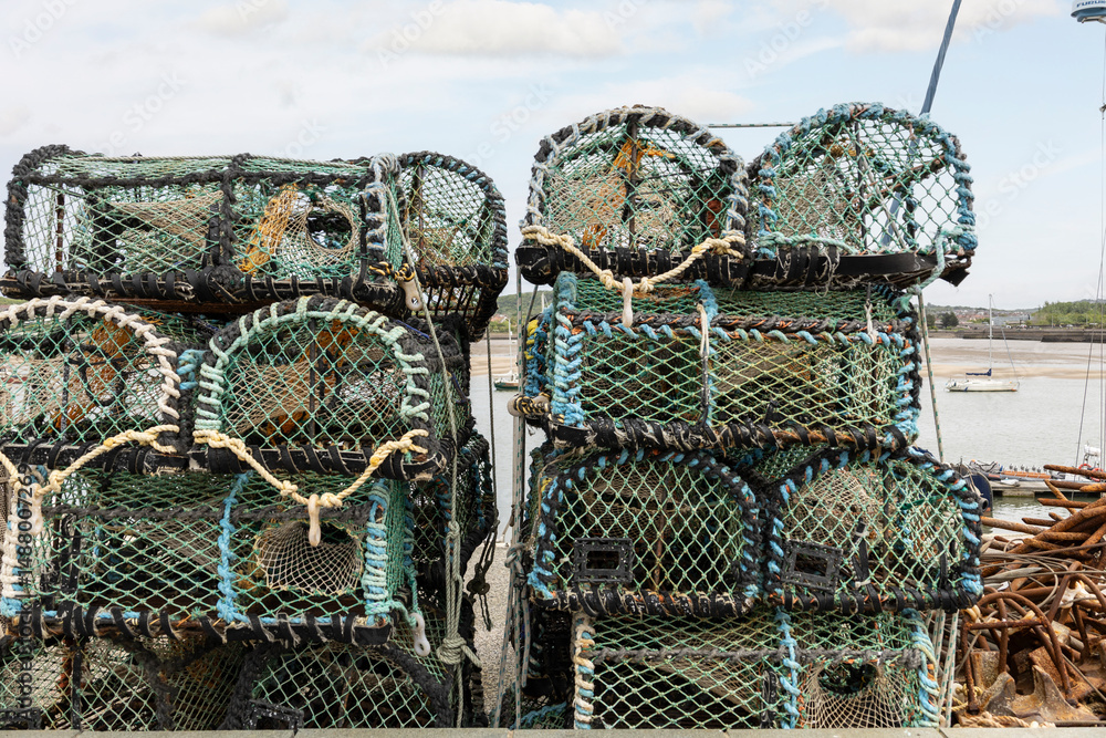 Crab traps stacked on a Harbor. Pile of lobster pots, sea side fishing concept Crab traps stacked on a Harbor. Pile of lobster pots, sea side fishing concept