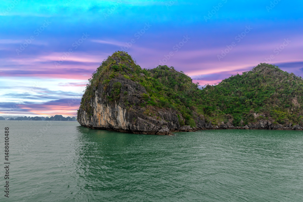 Fototapeta premium Halong Ha Long Bay Hanoi this Vietnamese wonder is littered with mountains and Rock cliffs popping out of the ocean, lush green mountains in Vietnam