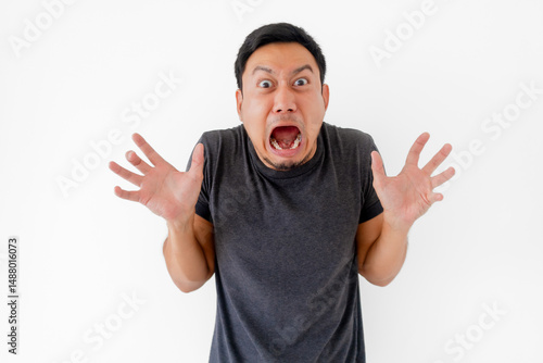 Funny man doing scary face and acting isolated on white background.
