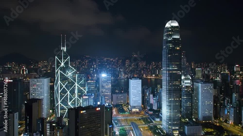 Wallpaper Mural This captivating view captures a bustling city skyline at night, highlighting the impressive buildings and lively streets. The glowing lights create a vibrant atmosphere that embodies urban life. Torontodigital.ca