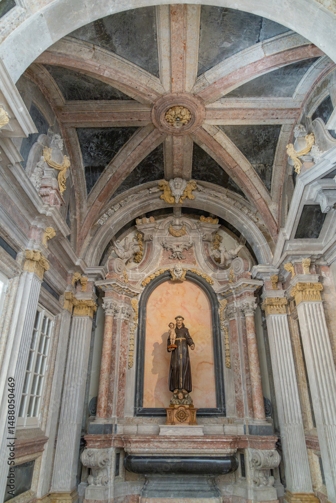 Fototapeta premium Baroque-style chapel interior with statue of Saint Anthony, featuring ornate marble columns, vaulted ceiling, in São Vicente de Fora Monastery church Lisbon, Portugal. 26 February 2025