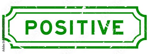 Grunge green positive word rubber seal stamp on white background