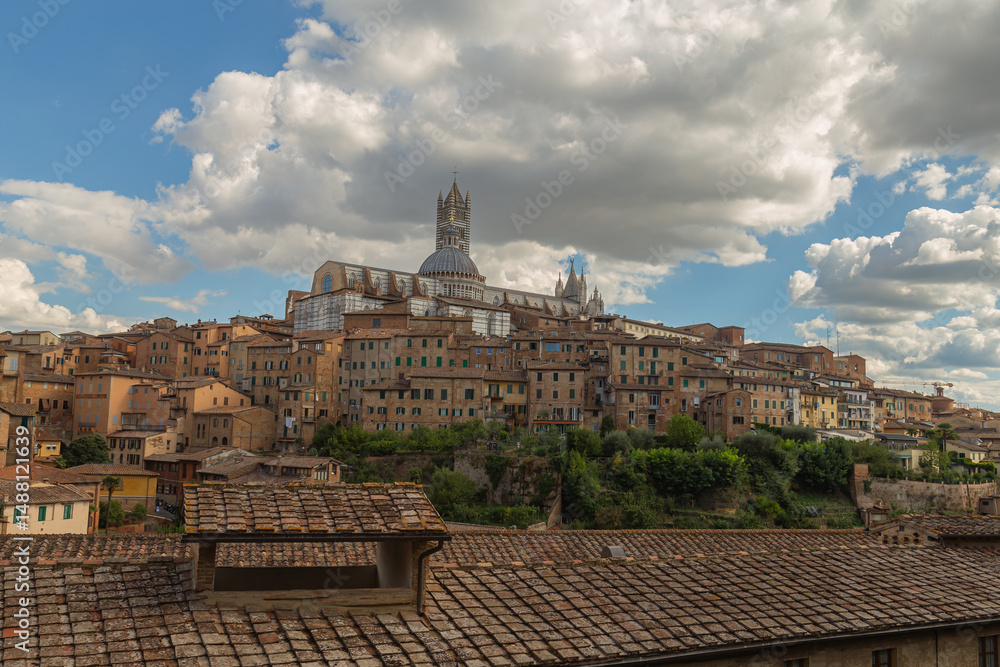 Obraz premium A view of Siena, Italy, featuring the Siena Cathedral and surrounding historic buildings. 