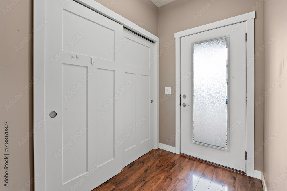 Fototapeta premium White door with a glass window and a wooden floor